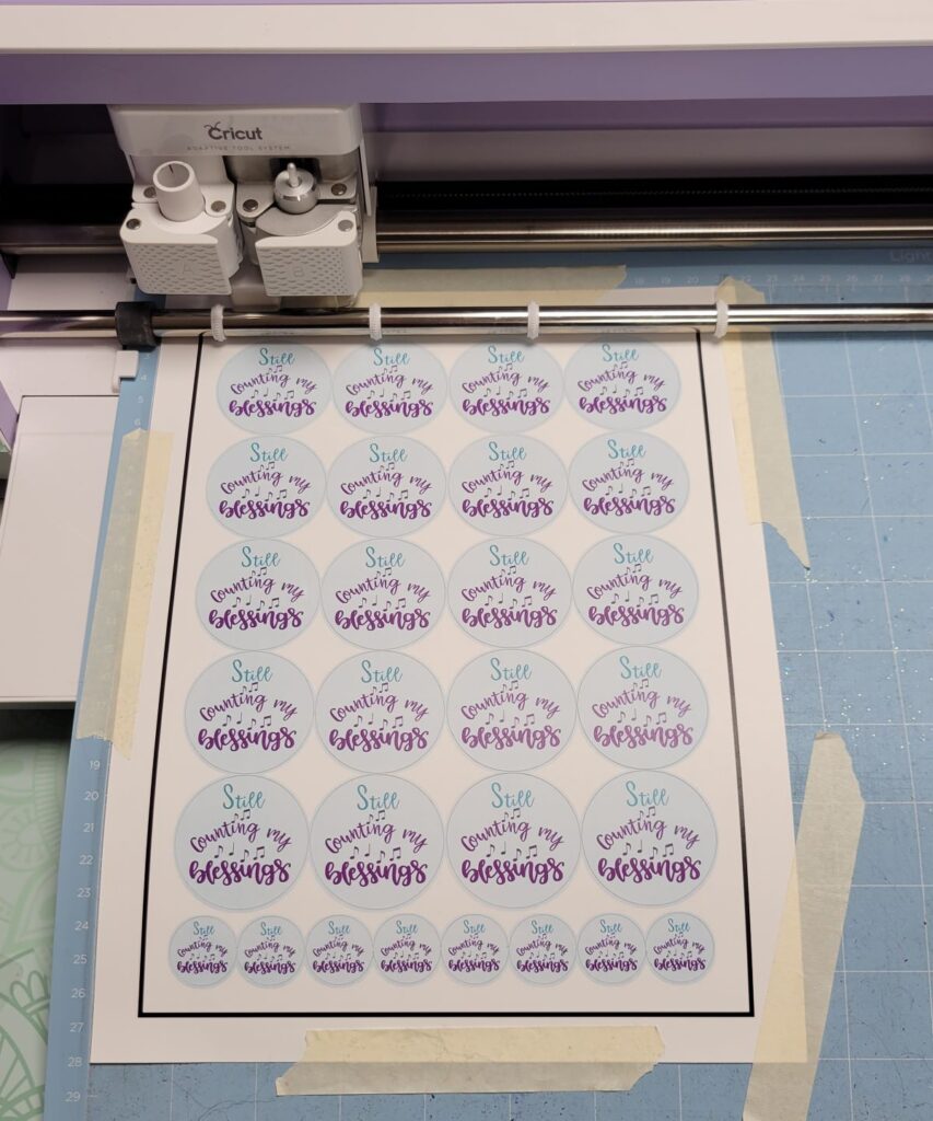 sheet of stickers being cut on Cricut machine