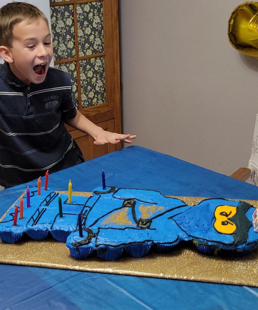 boy sees Lego Man Cake