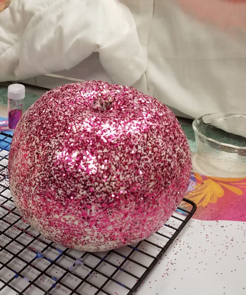 pink glitter on pumpkin