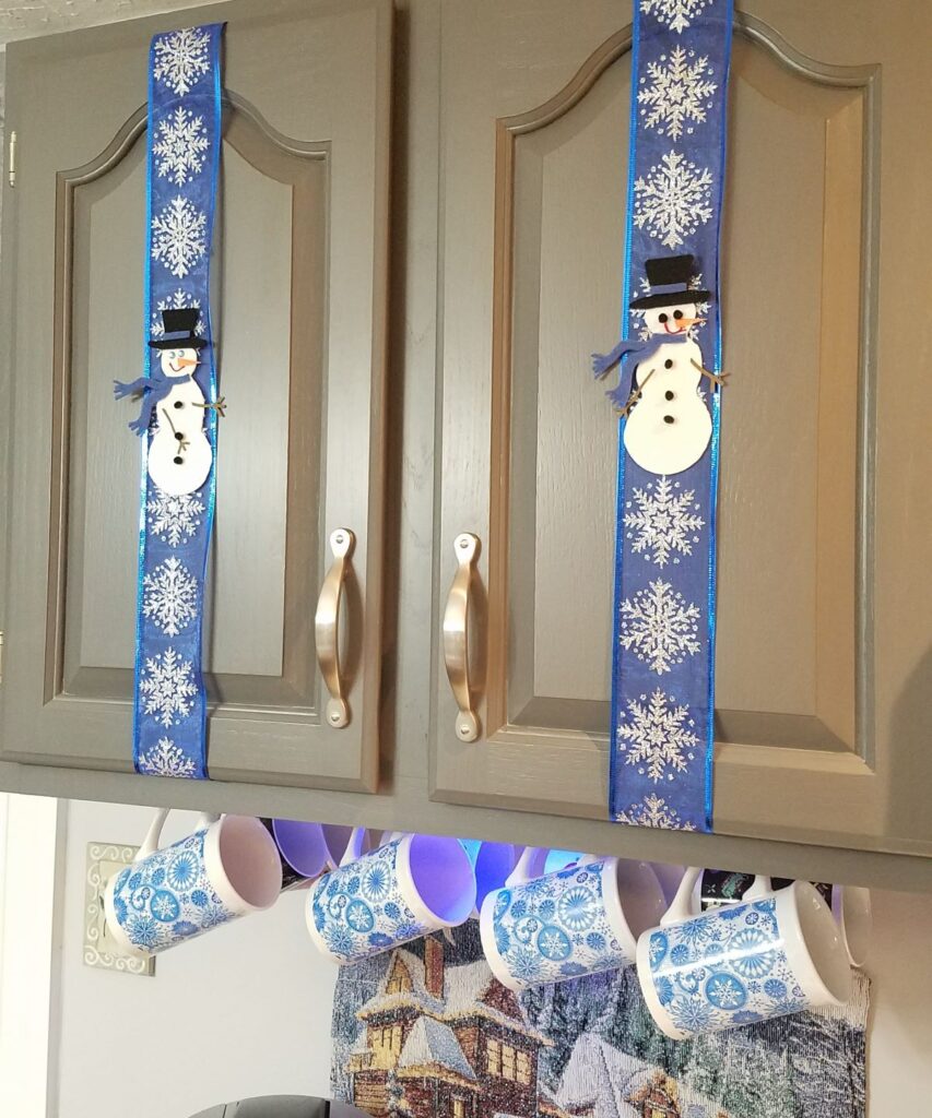 snowmen decor on gray cabinets