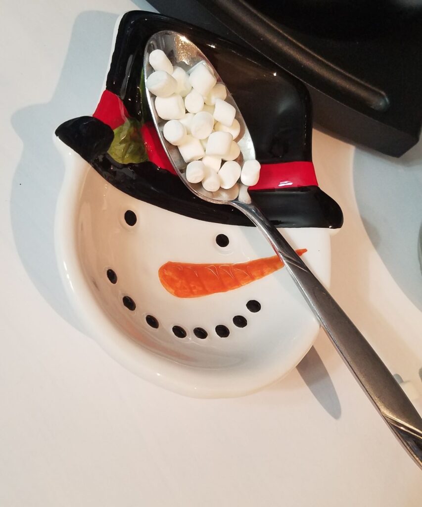 snowman spoonrest with marshmallows on spoon