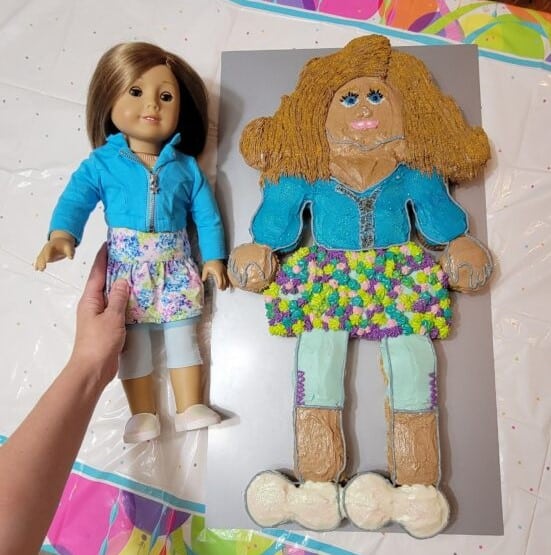american girl doll next to a matching cake