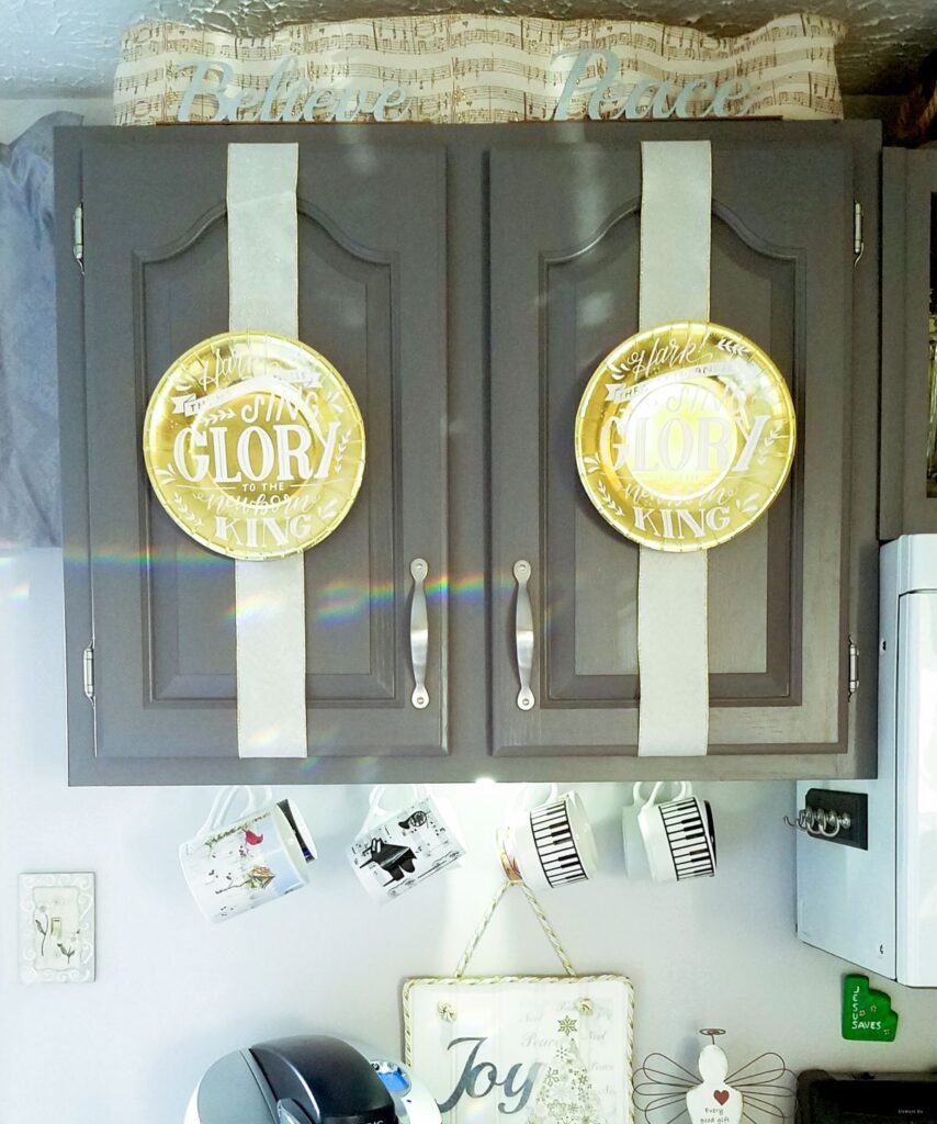 gold paper plates on cabinets with ribbon