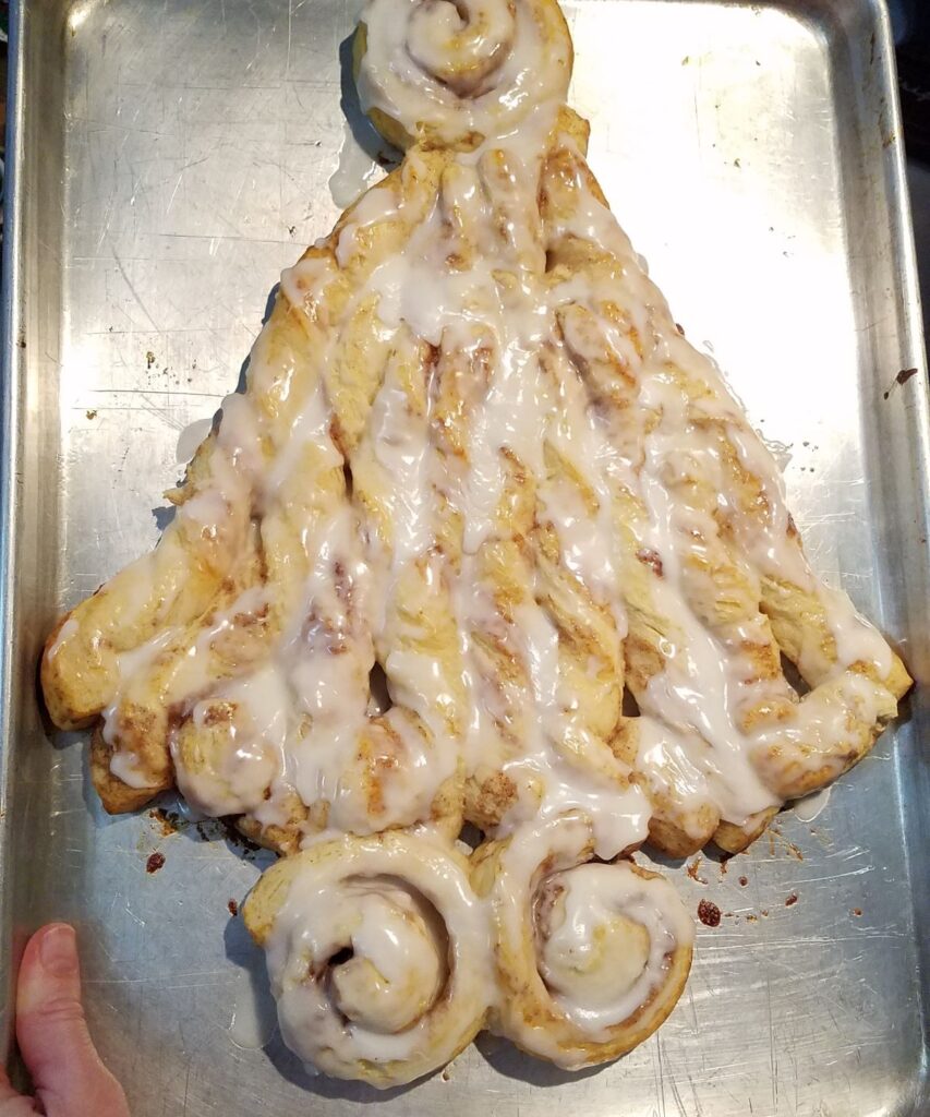 tree shaped cinnamon roll with frosting on it