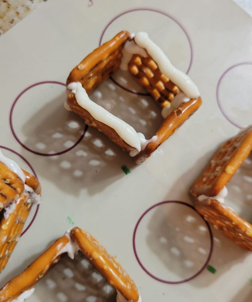 white frosting on square pretzels