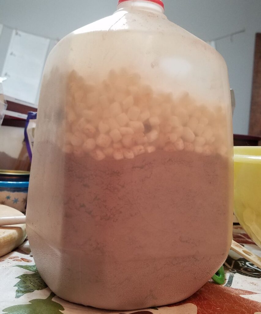 milk jug with brown powder and mini marshmallows in it