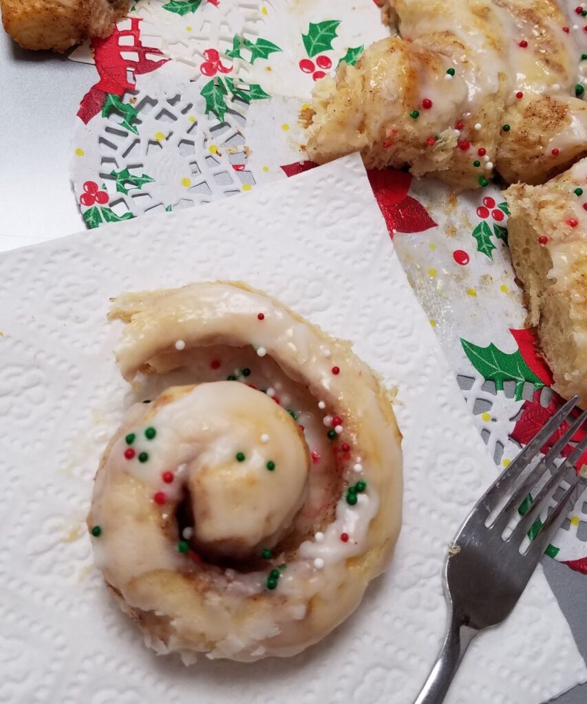 cinnamon roll with red, green, and white sprinkles