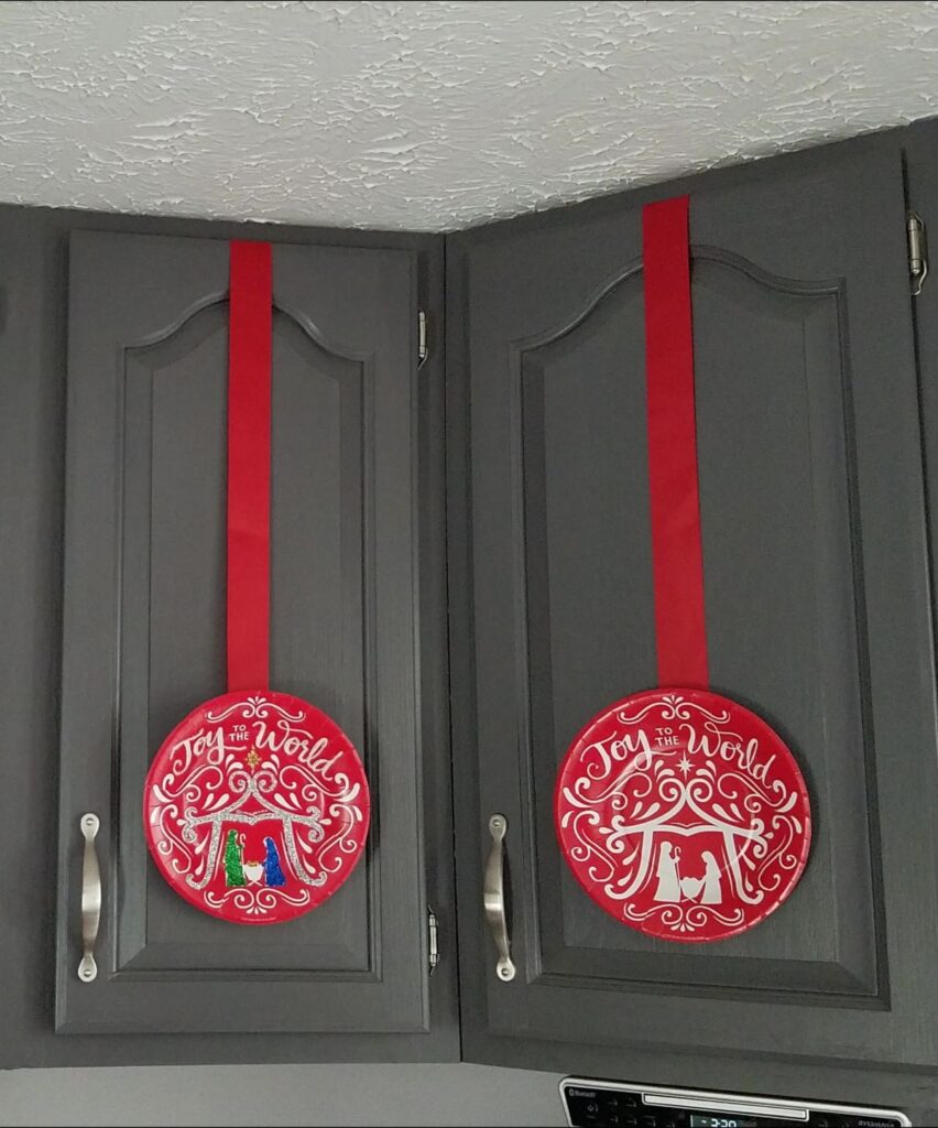 two Christmas paper plates on cupboards