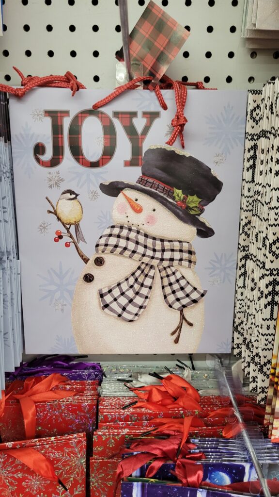 black and white scarf on snowman gift bag