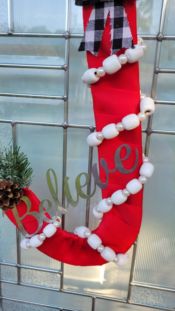 closeup of Believe word on wreath