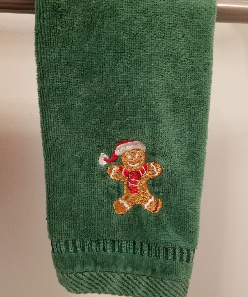green towel with gingerbread man on it