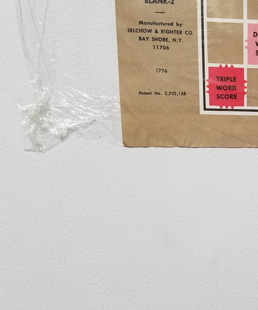 plastic wrap to hold the paper to the fridge