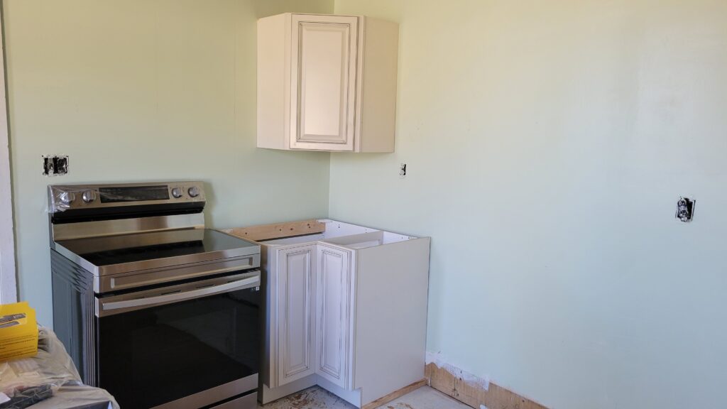 cabinet in kitchen with green walls