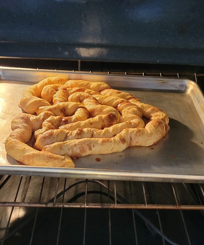 cinnamon roll cooking in the oven