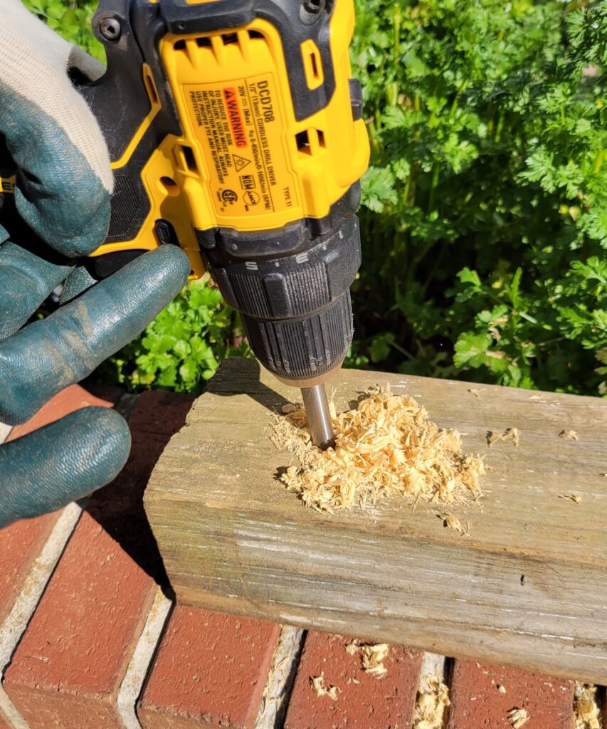 drilling a hole in fence post