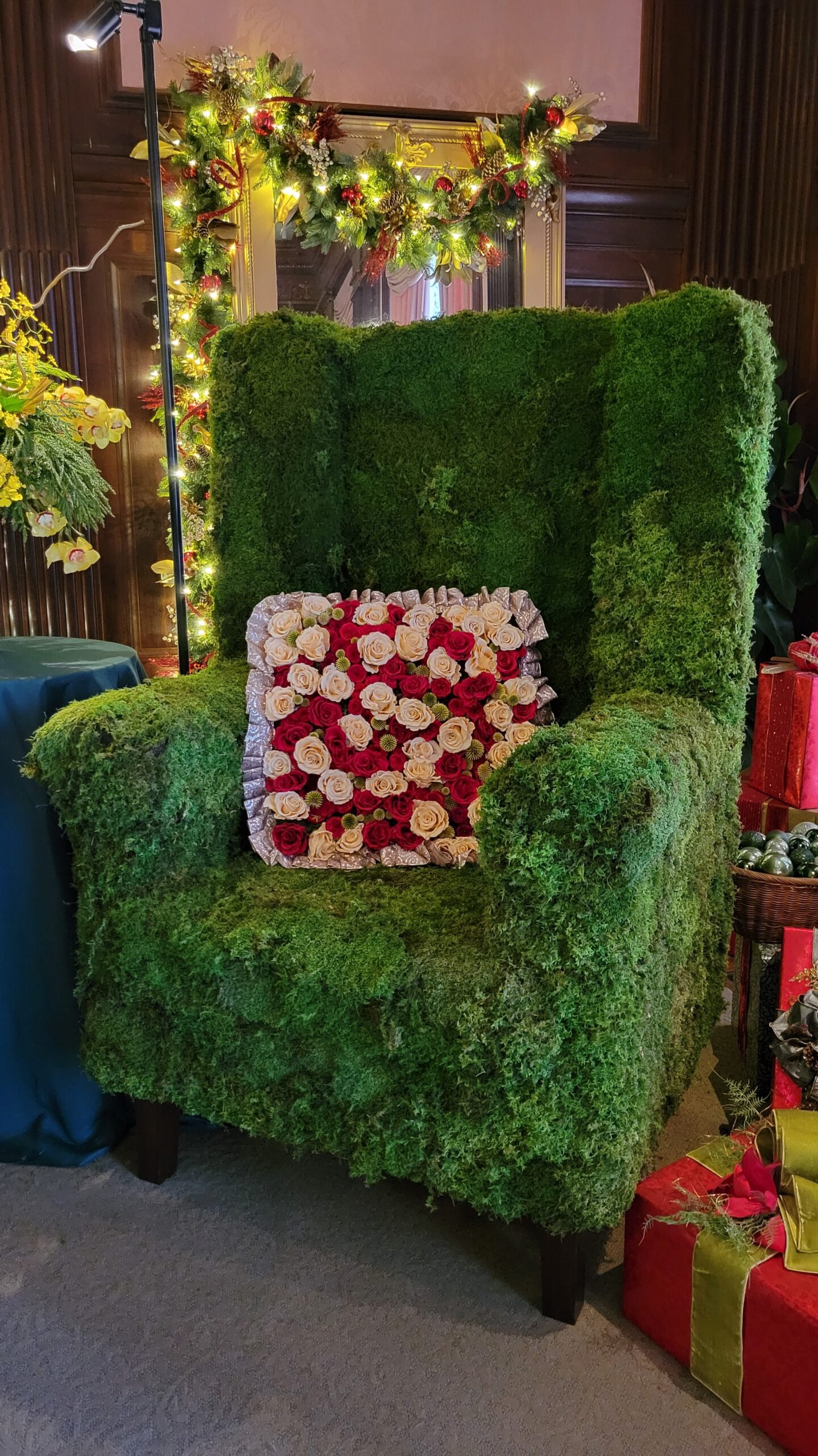 moss covered chair with flower pillow