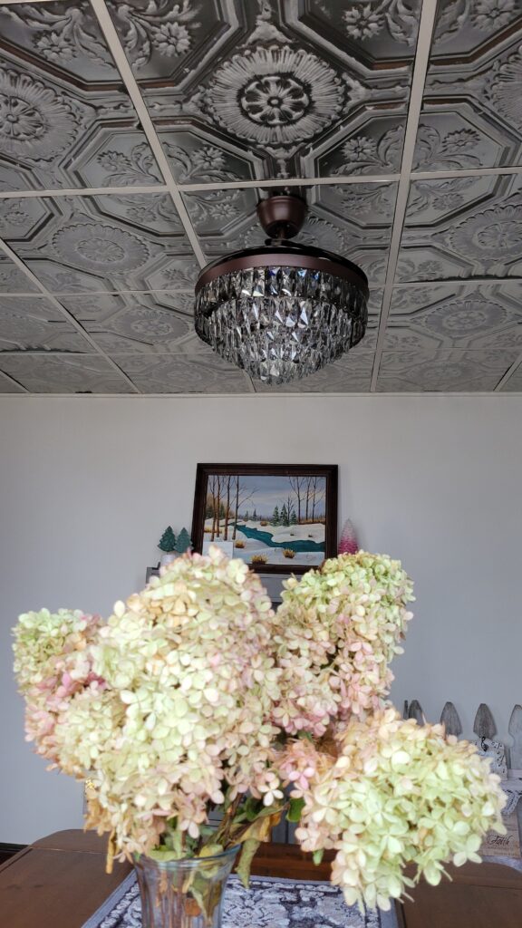 flower arrangement and tin ceiling