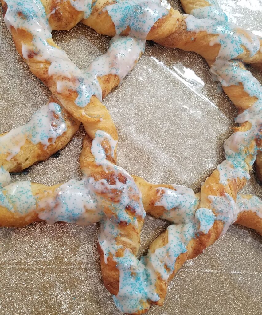 blue sprinkle sugar on cinnamon roll