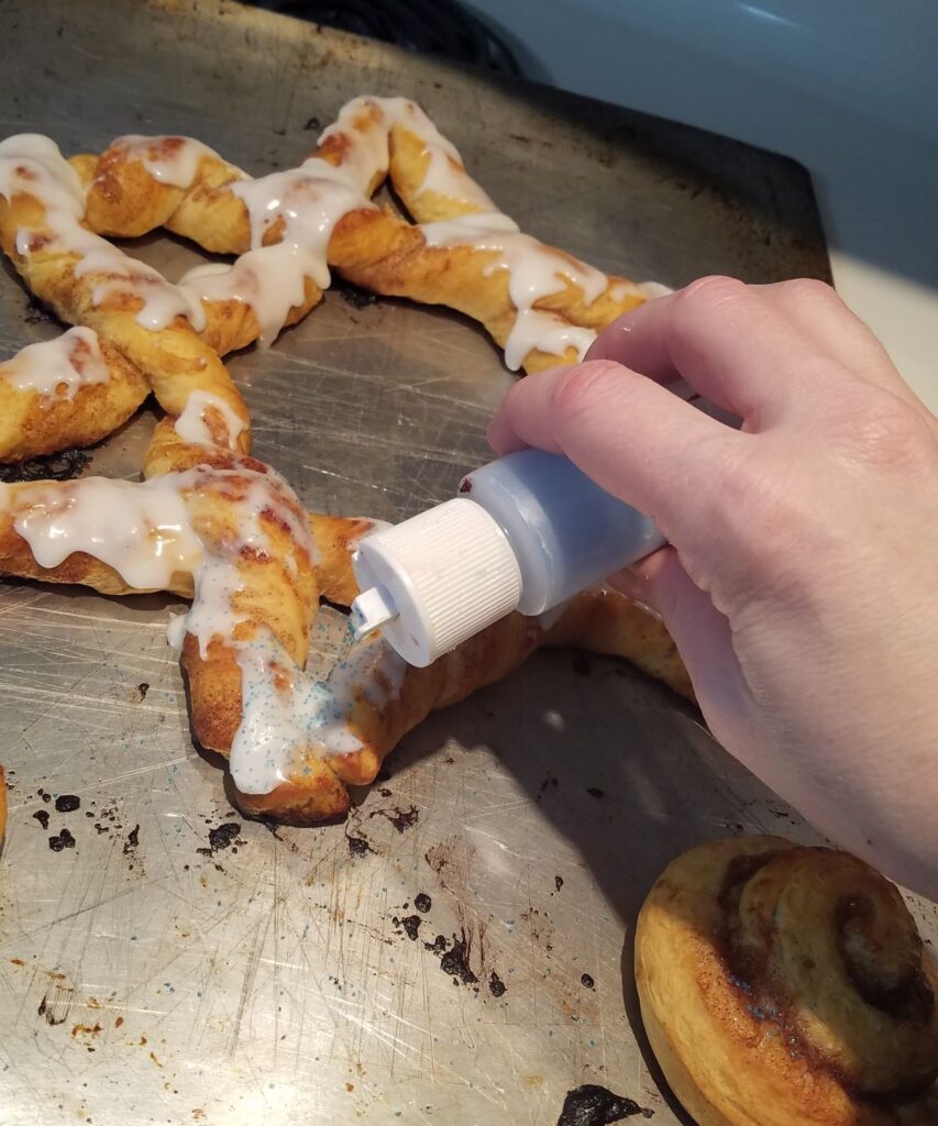 sprinkling sugar on cinnamon roll