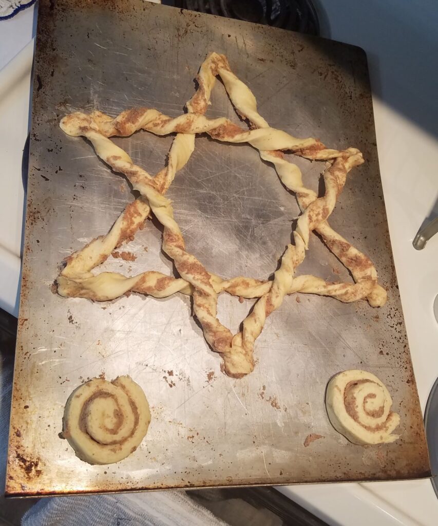 star shaped cinnamon roll on baking sheet