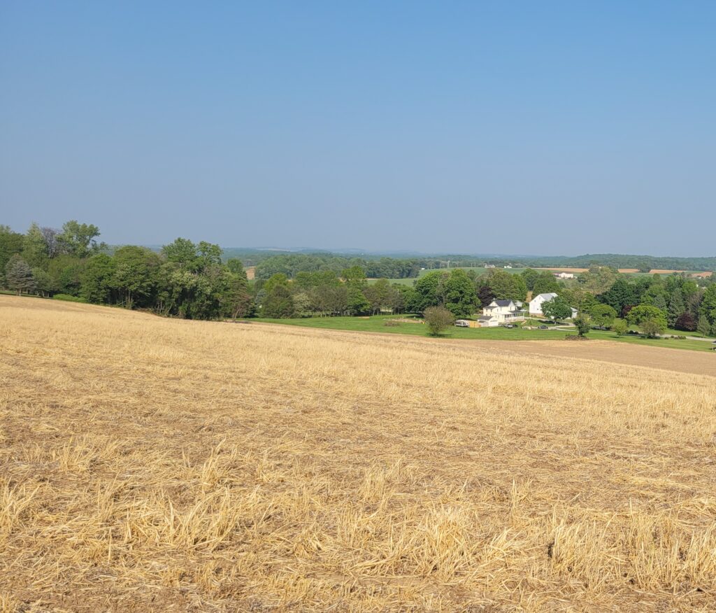 farmer's field with house in distance