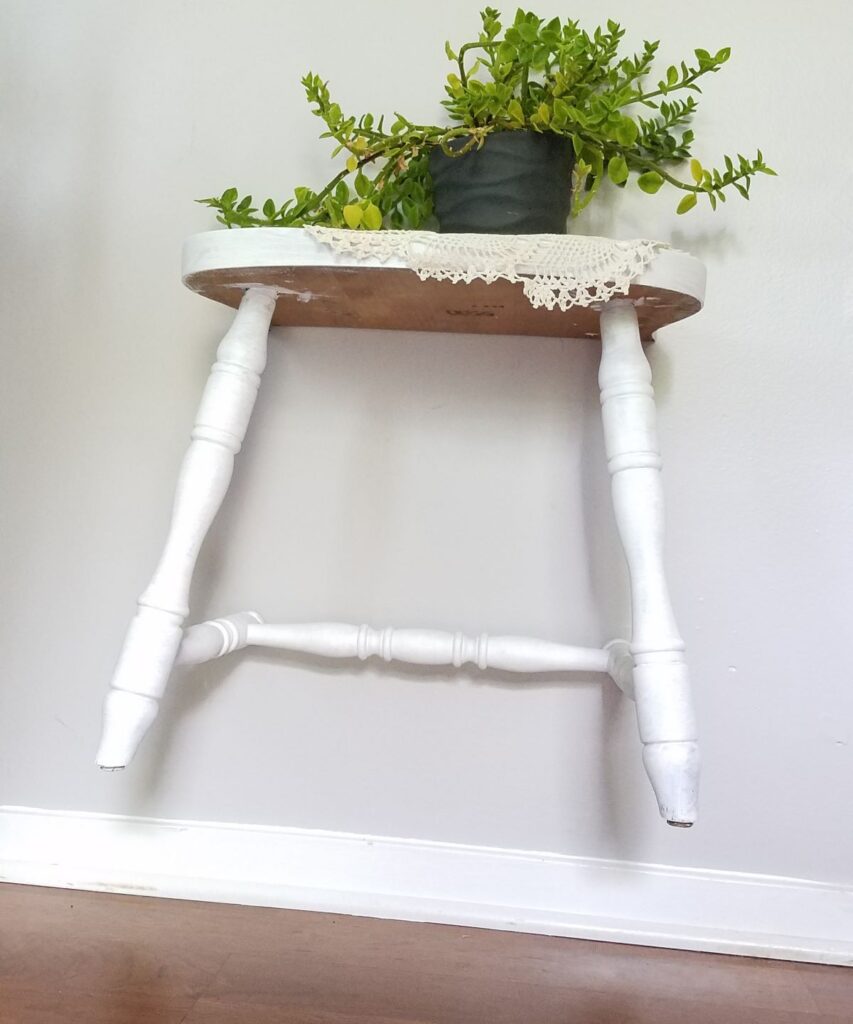 white painted chair half on wall