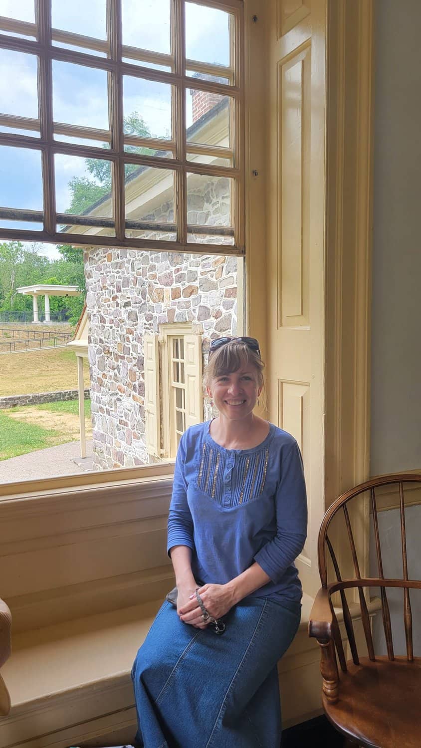 woman sitting in window ledge