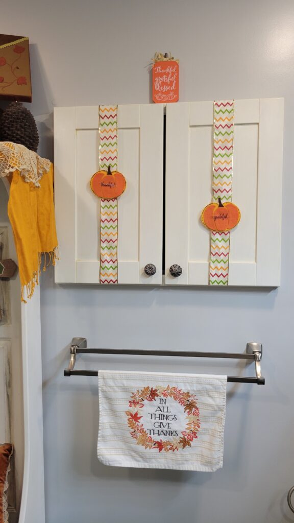 cabinets with pumpkin felt shapes and ribbon for fall