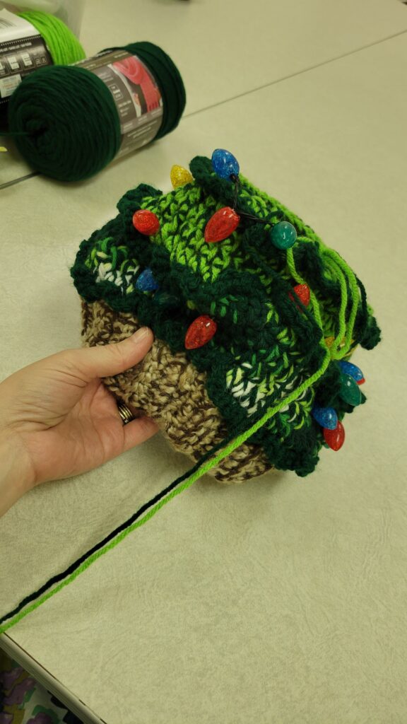 hand holding partial hat
