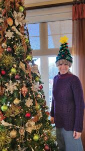 woman wearing a hat in the shape of a Christmas tree