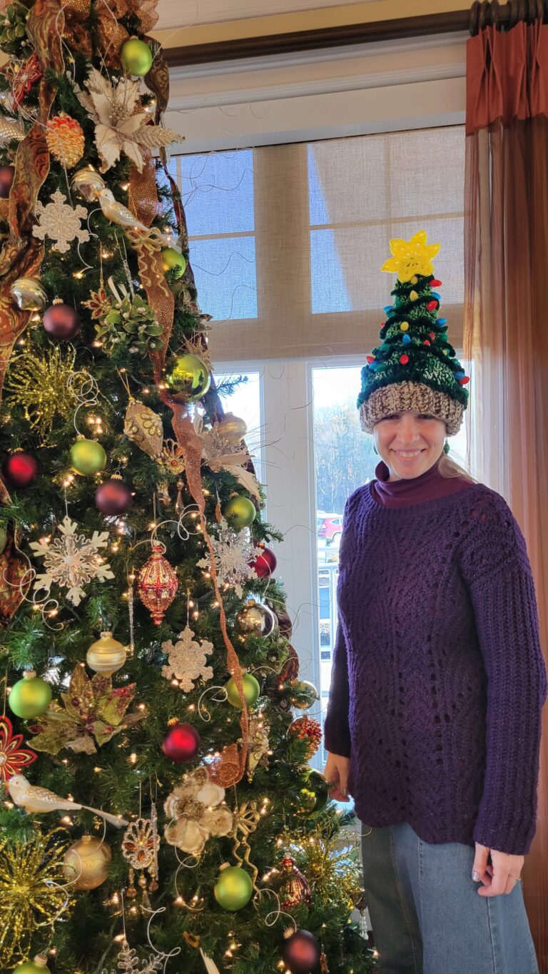 woman wearing a hat in the shape of a Christmas tree