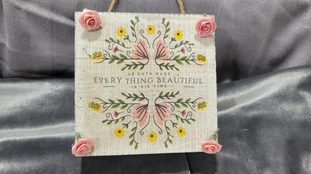 pink and yellow sign with small pink roses