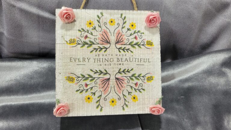pink and yellow sign with small pink roses