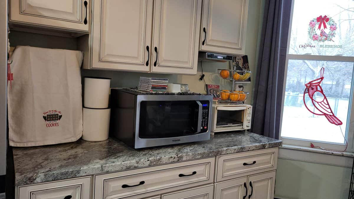 kitchen counter with microwave and under cabinet CD radio player