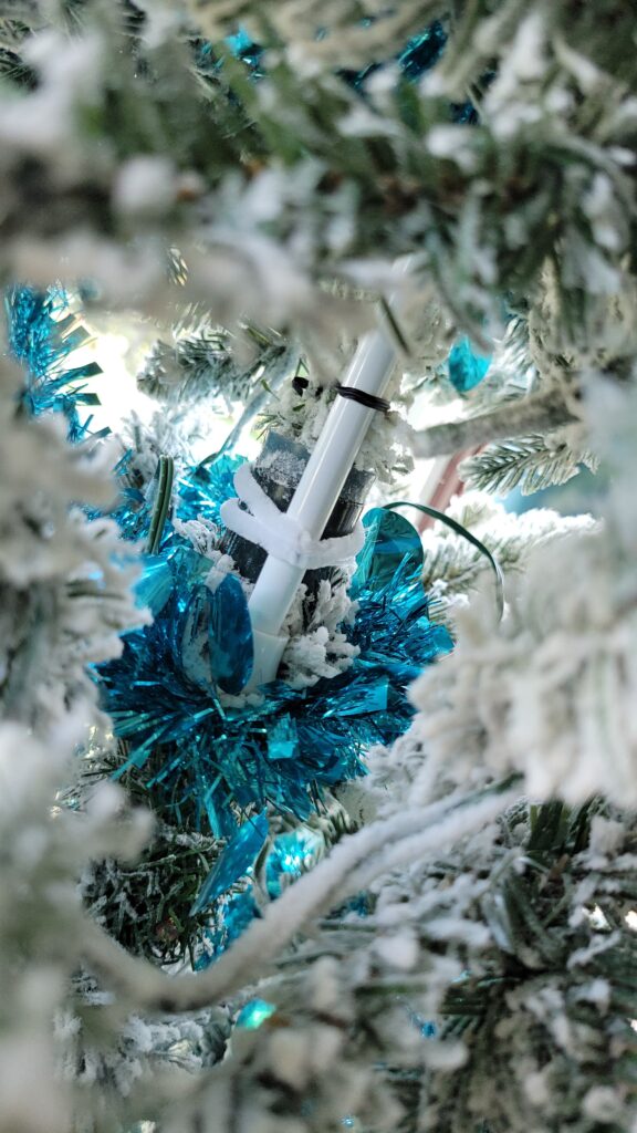 curtain rod tied to Christmas tree