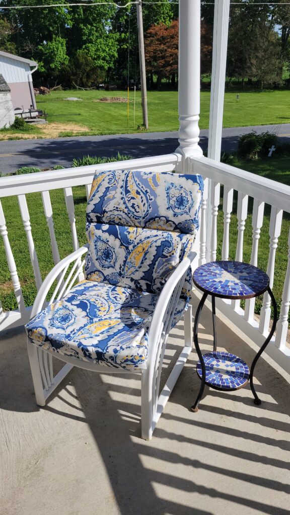 blue and white patio chair on a porch