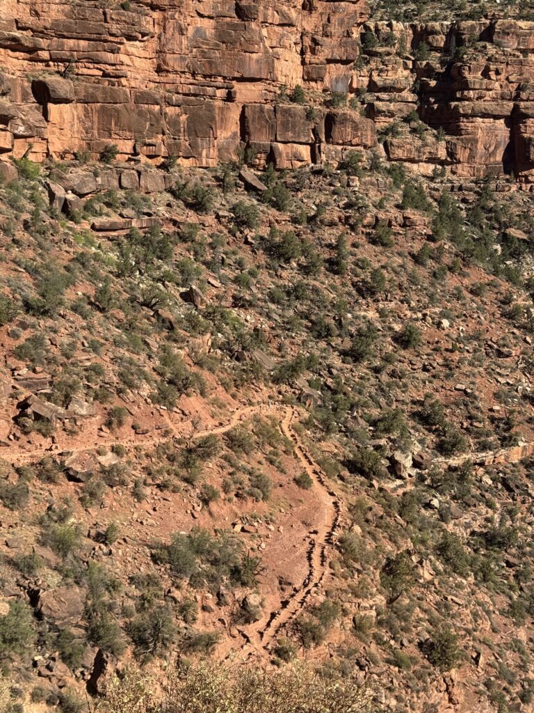 person far in the distance on canyon trail