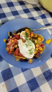 salsa in a bowl with sour cream and a spoon