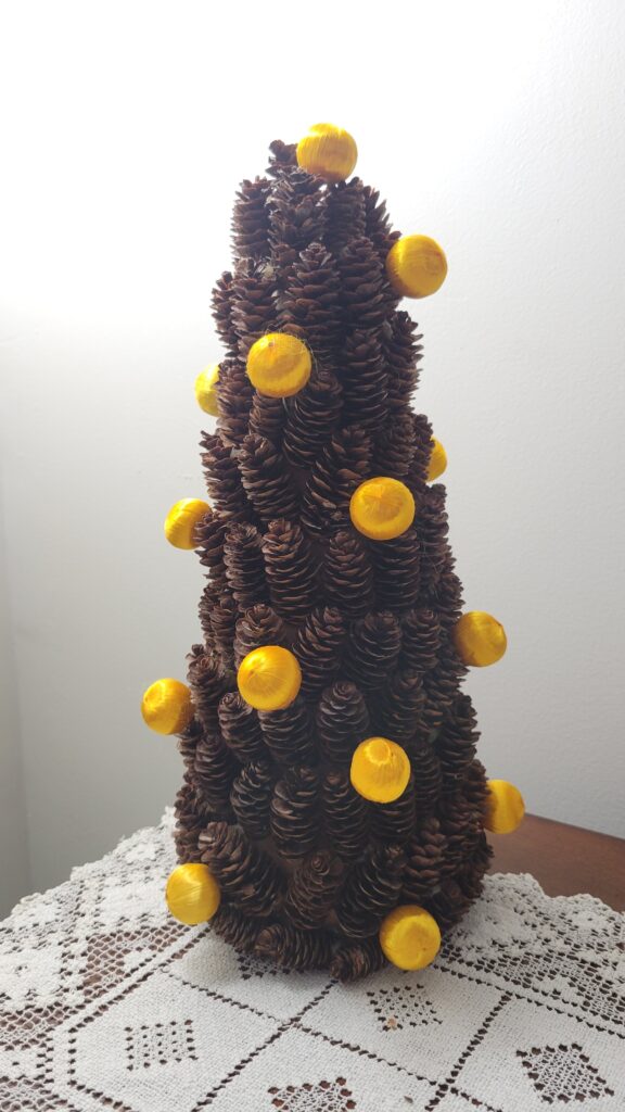 Pine cone tree with yellow ornaments